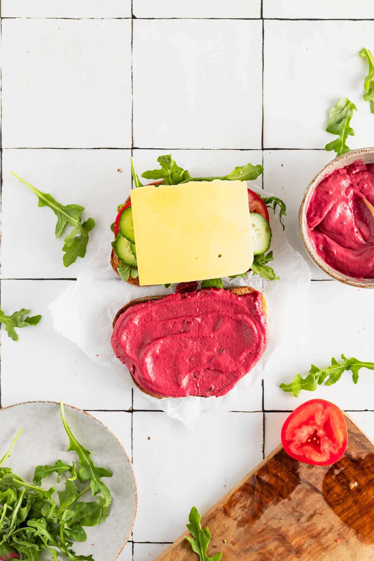 Vegan cheese added to hummus sandwich.