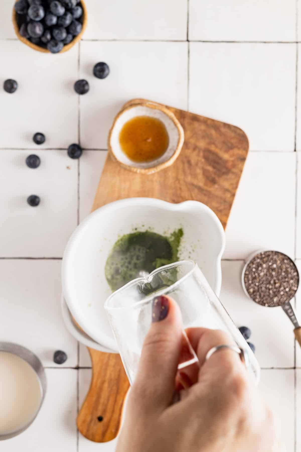 Pouring hot water over ceremonial grade matcha.