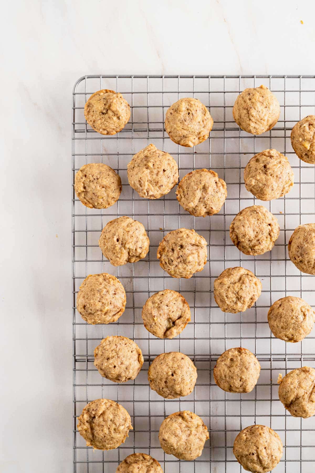 Mini banana muffins on a cooling rack.
