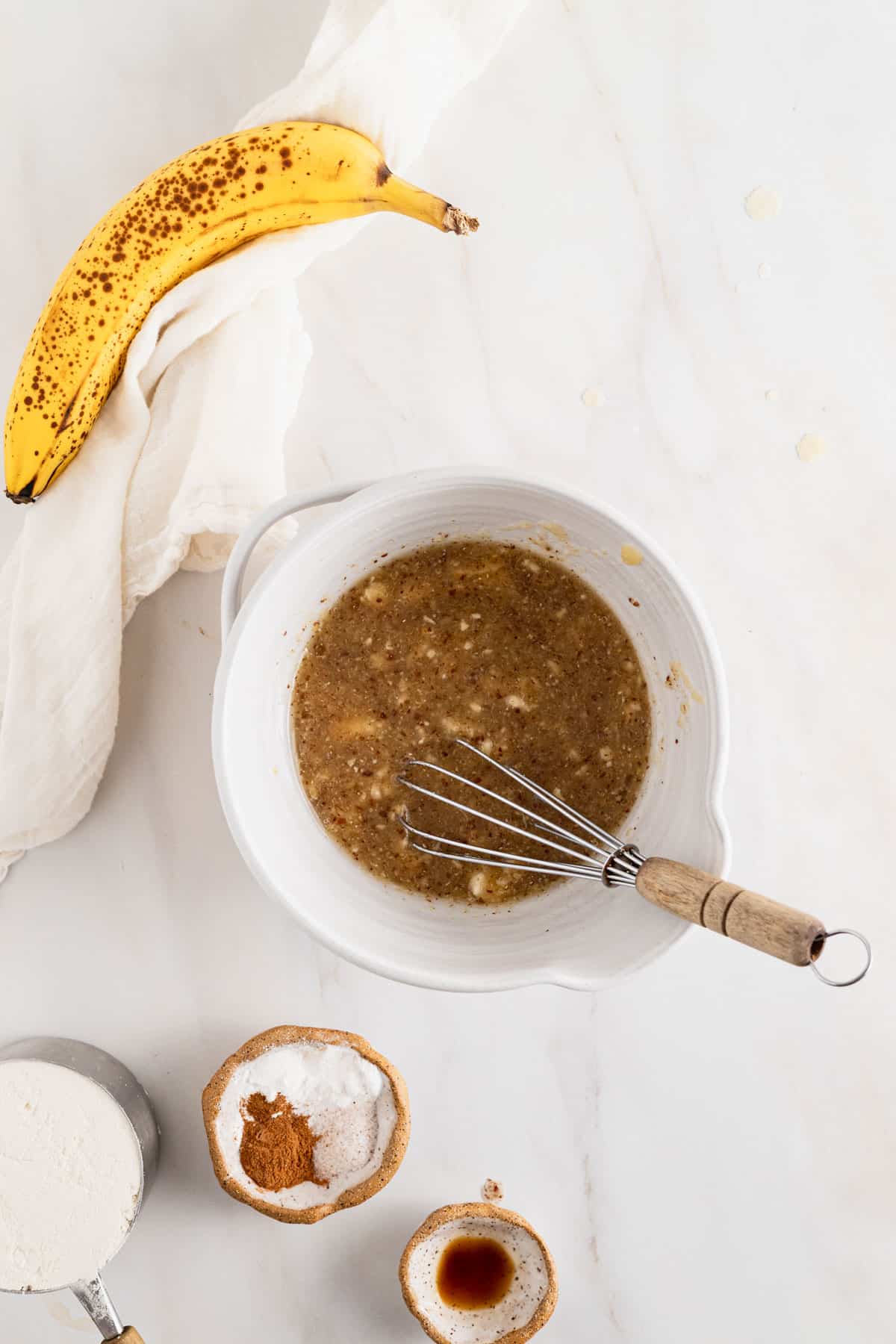 Combining wet ingredients in a small mixing bowl.