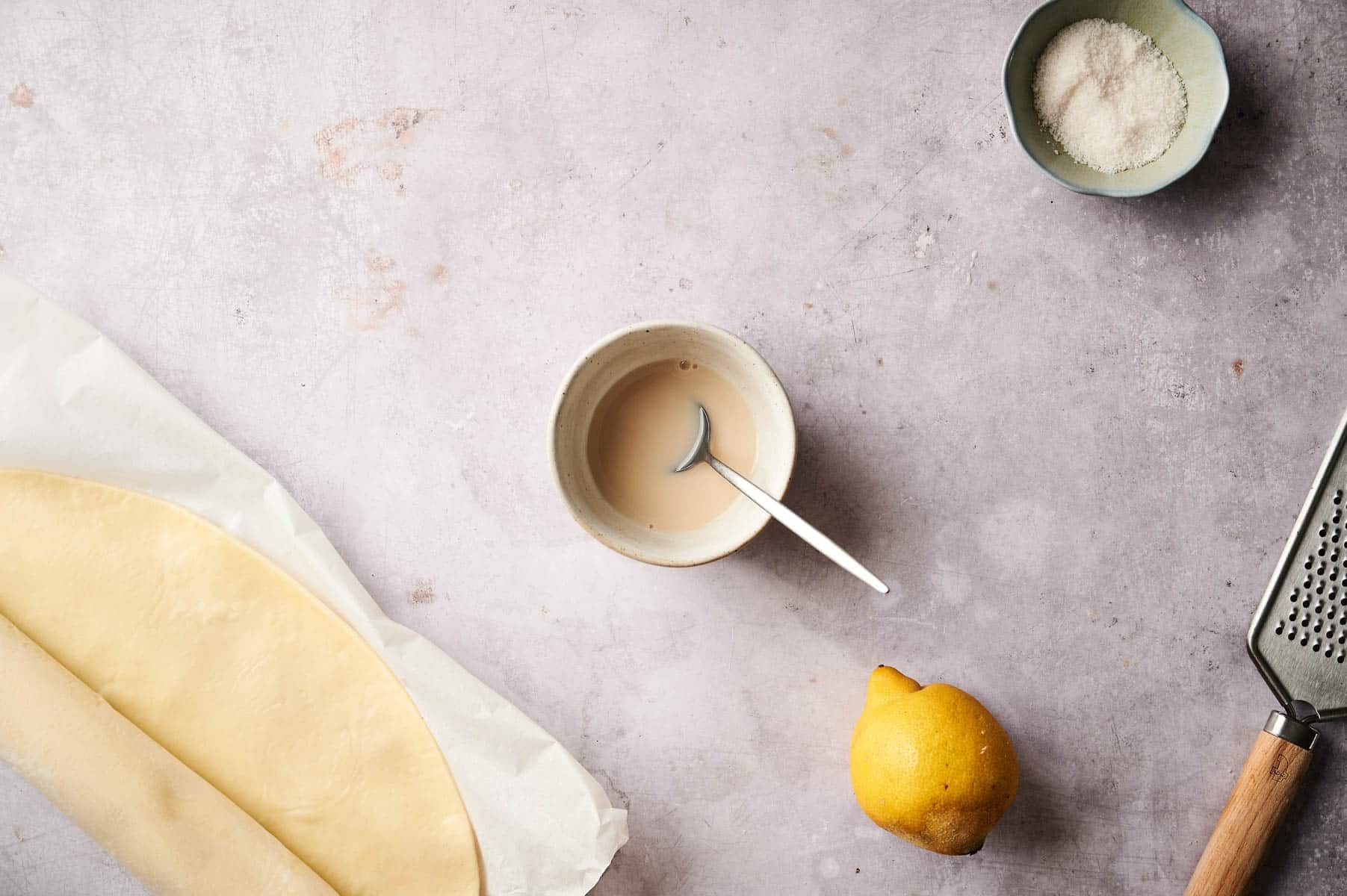 Mixing together the vegan egg wash in a small white bowl.
