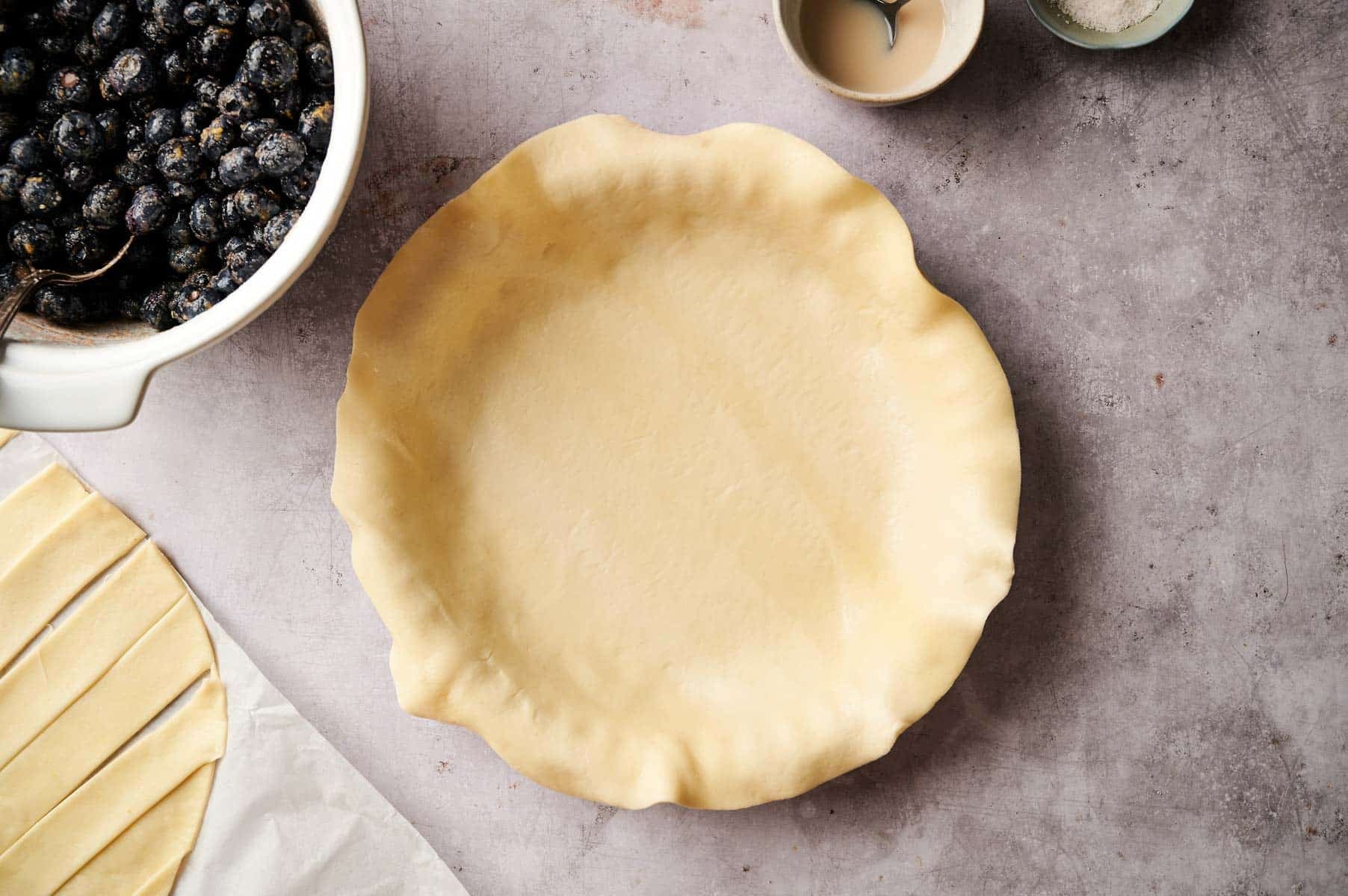 Preparing pie dough for berry pie.