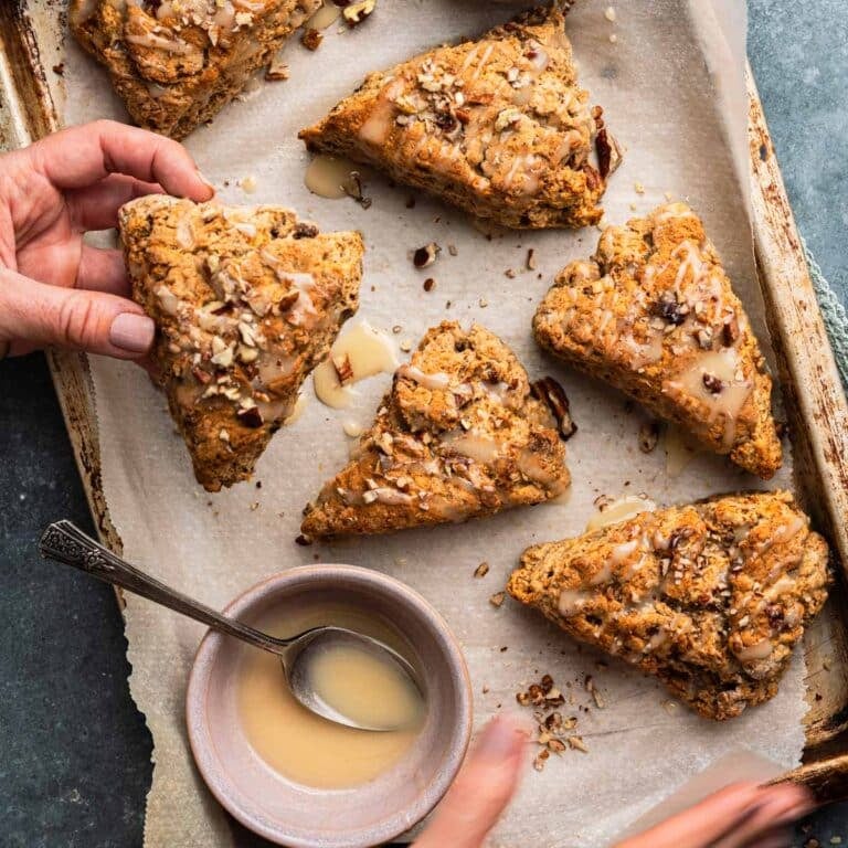 Woman holding a banana nut scone.