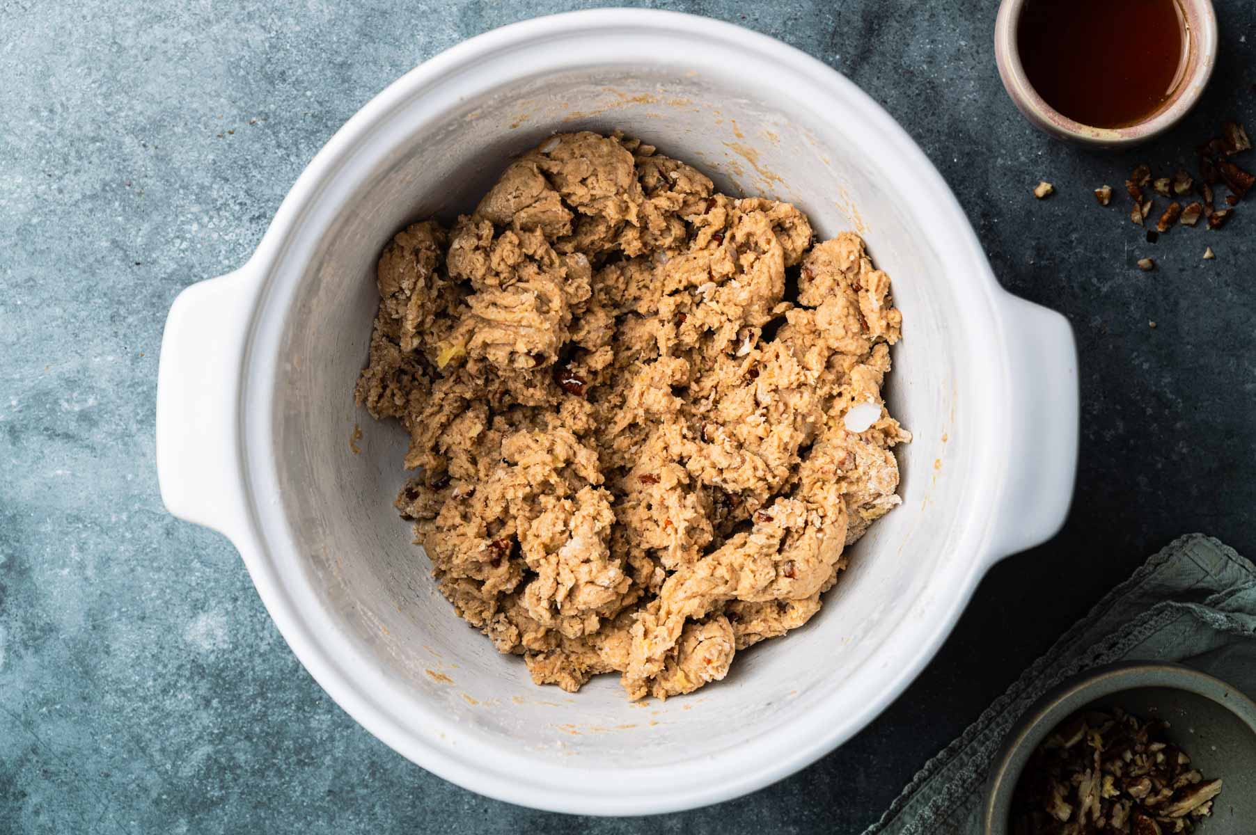Banana scone dough being combined in a large mixing bowl.