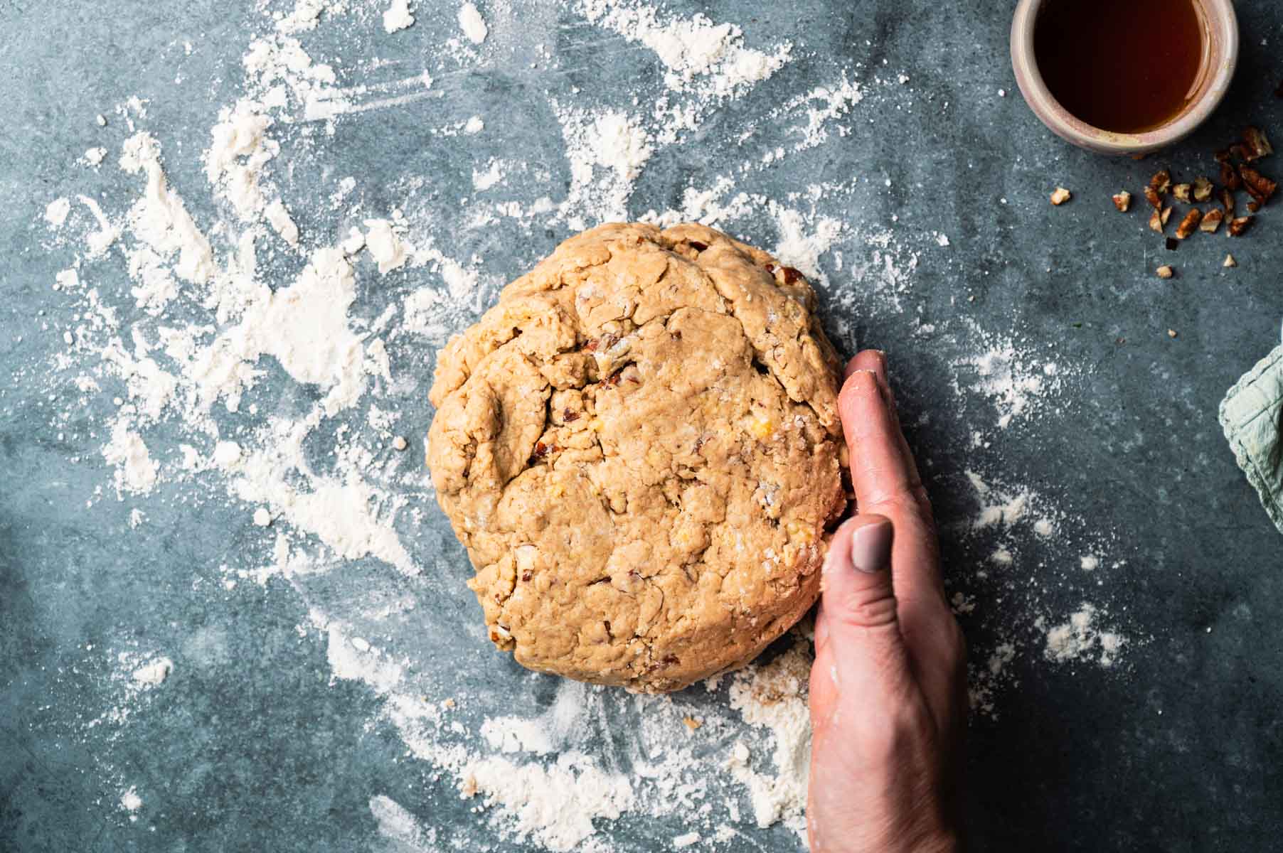 Shaping vegan banana scones into a round disk.