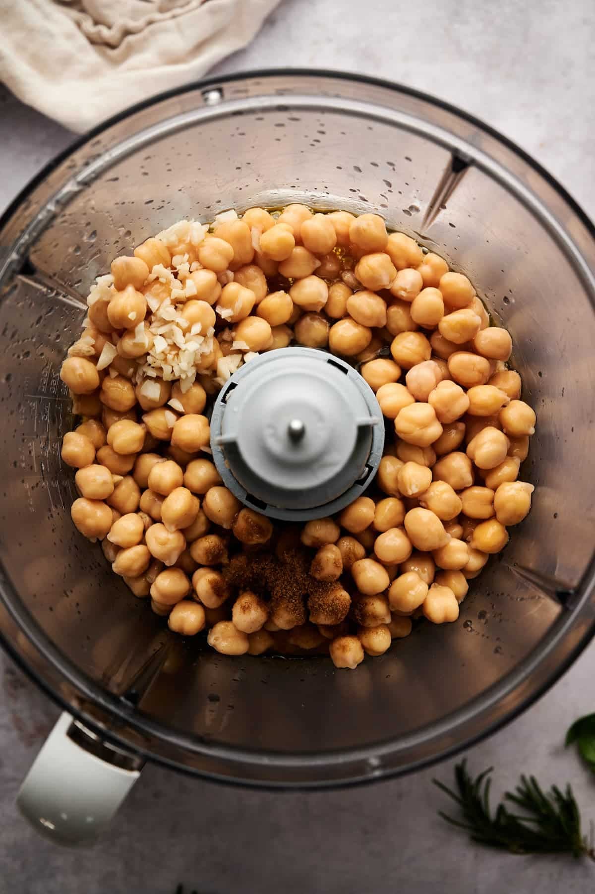 Ingredients for hummus minus the tahini in a food processor.