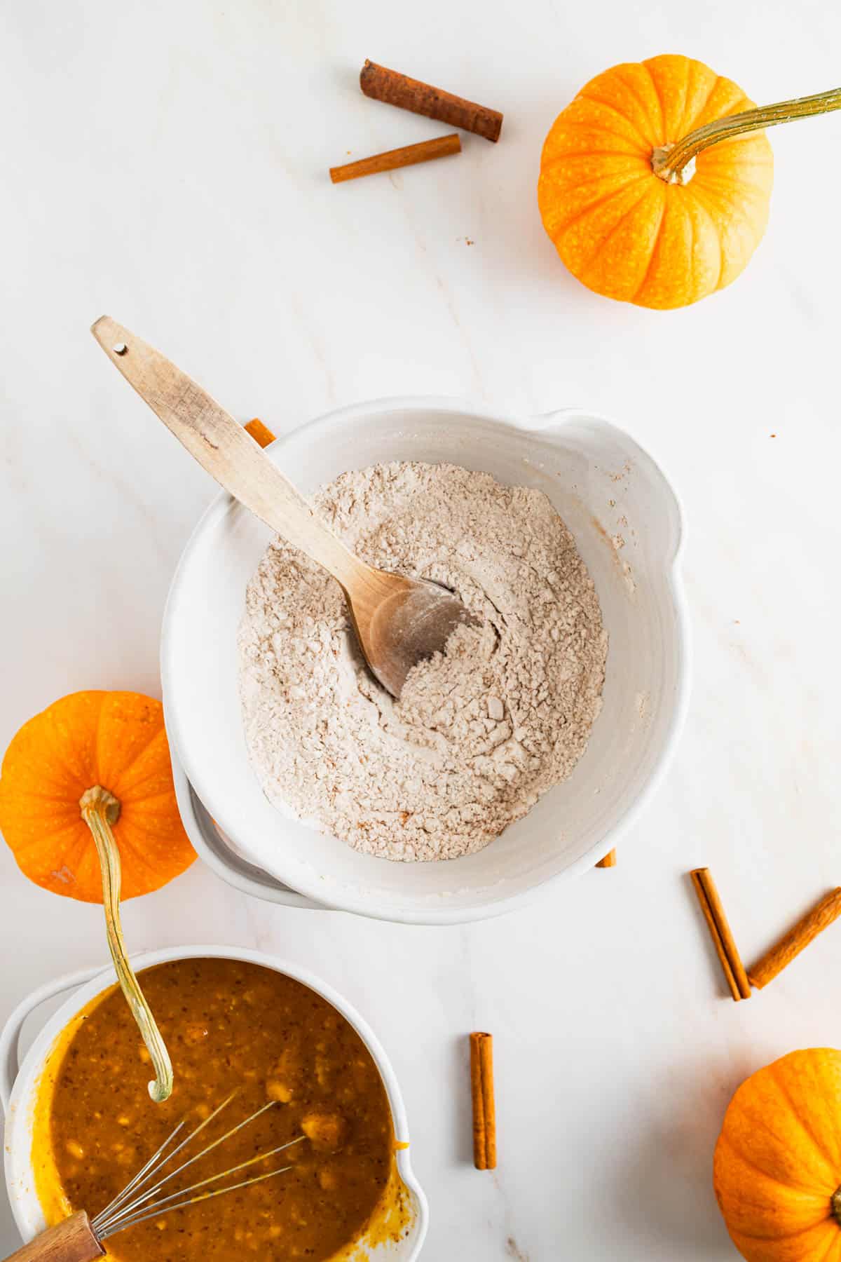 Dry muffin ingredients added to a large mixing bowl and stirred together.