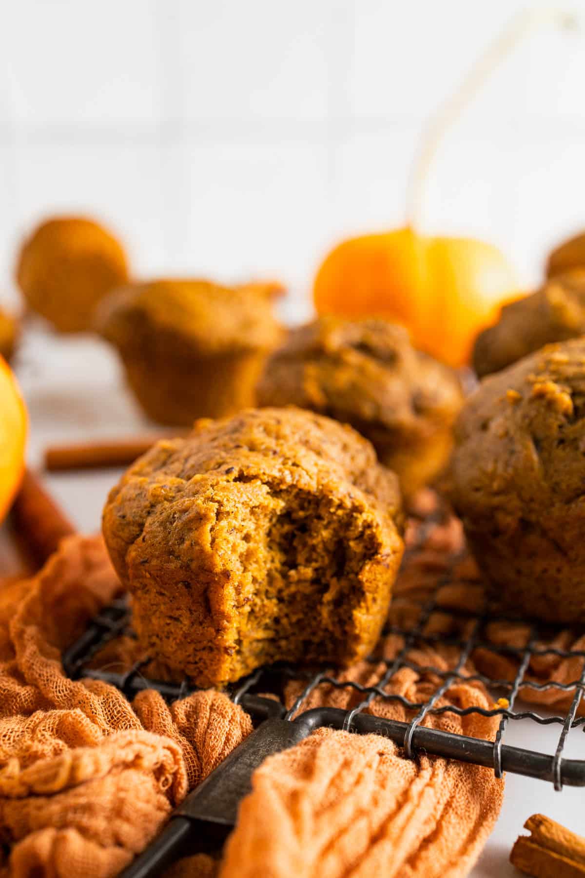 Baked pumpkin banana muffins with a bite taken out of one.
