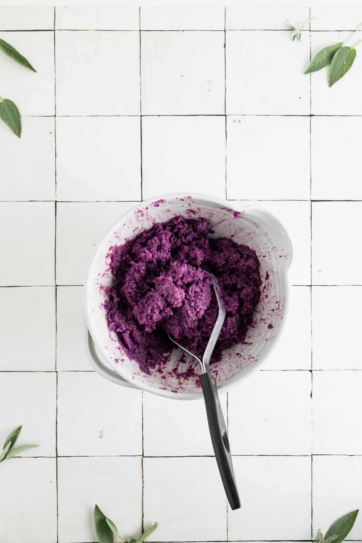 Mashing the ingredients for homemade vegan sweet potatoes.