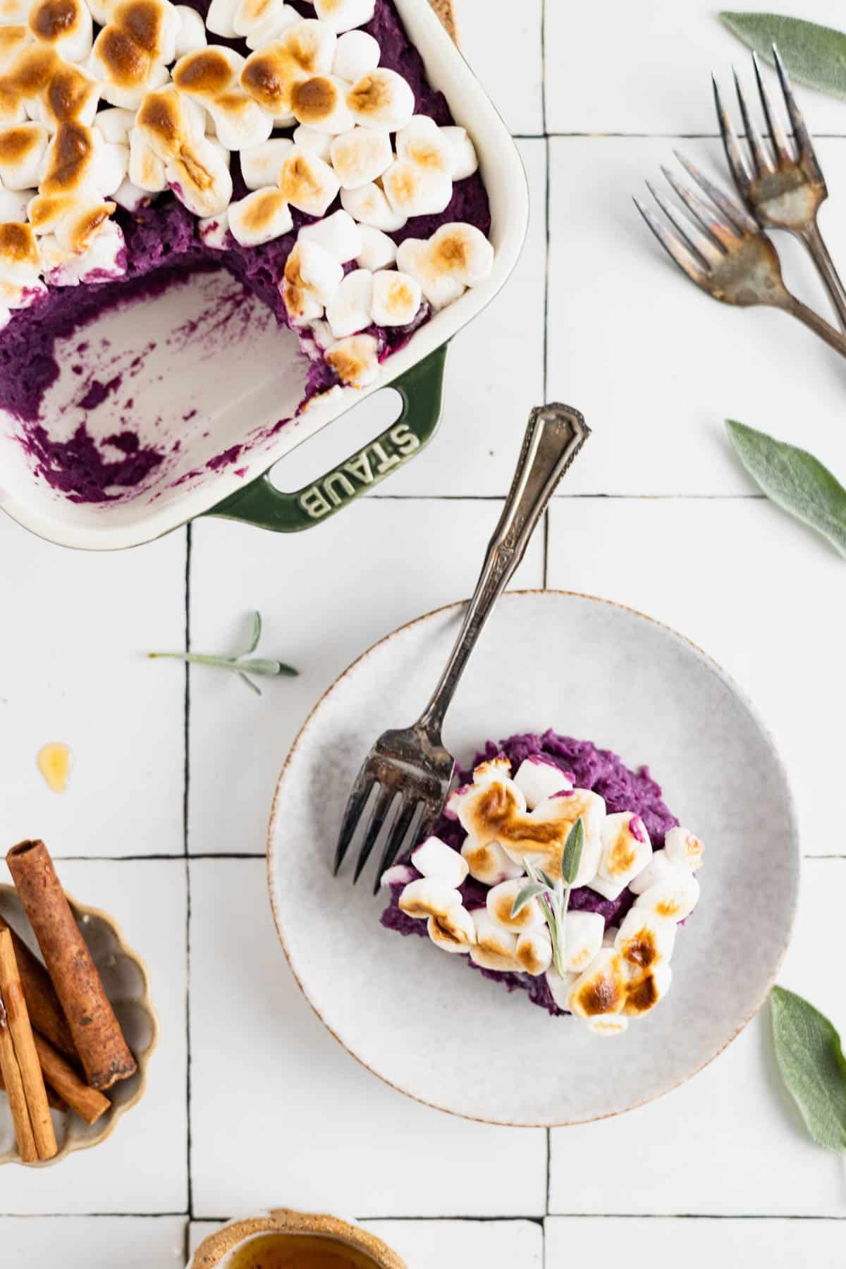 Sweet potato casserole in a baking dish with a piece cut out on a plate.