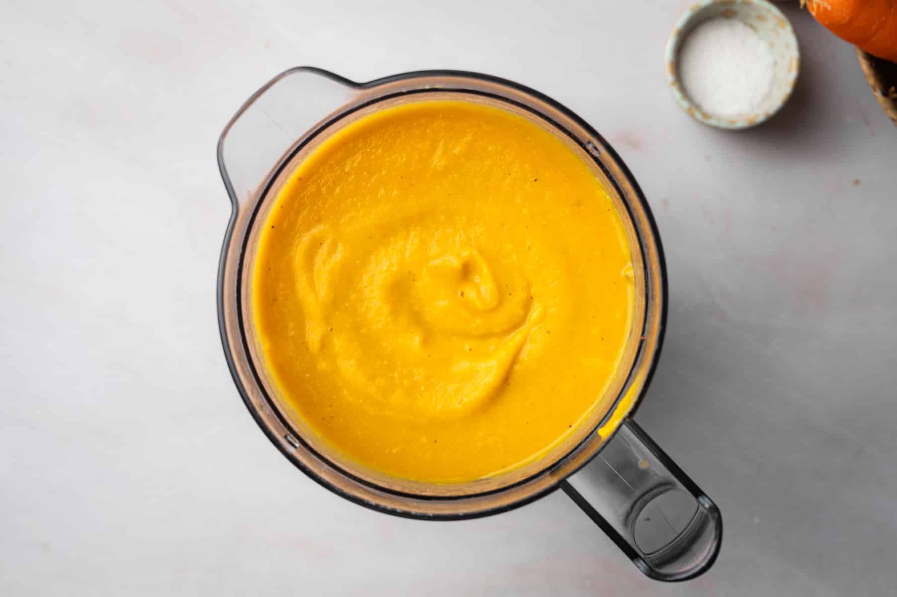 Lentil and carrot soup added to a blender and pureed.