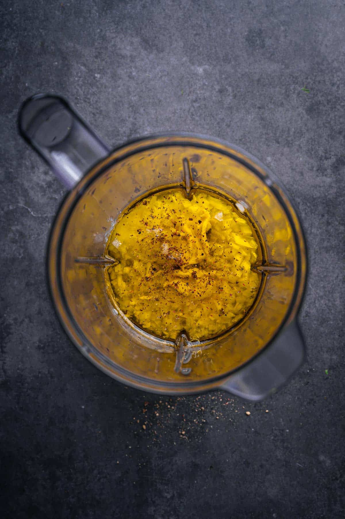 Ingredients for sweet onion and citrus dressing in a blender.