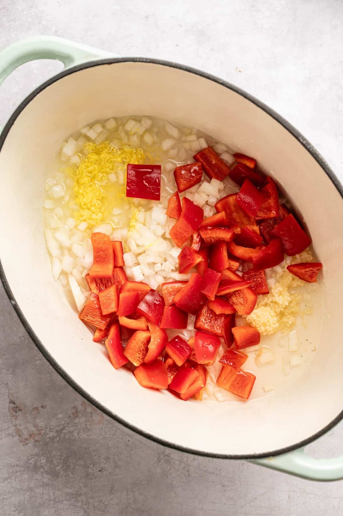 Sautéing onion, ginger, garlic, and bell pepper.