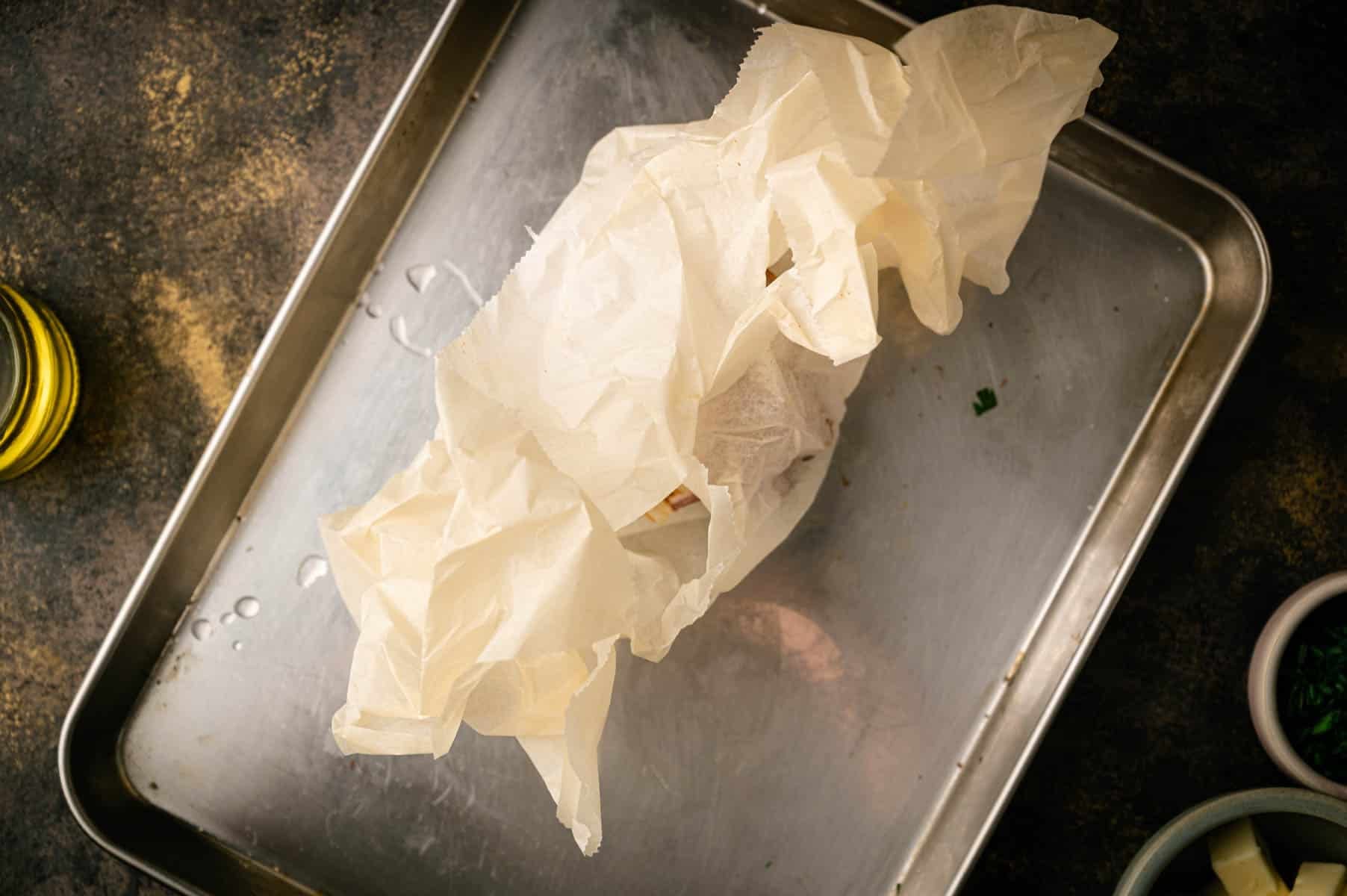 Roasting garlic in parchment paper.
