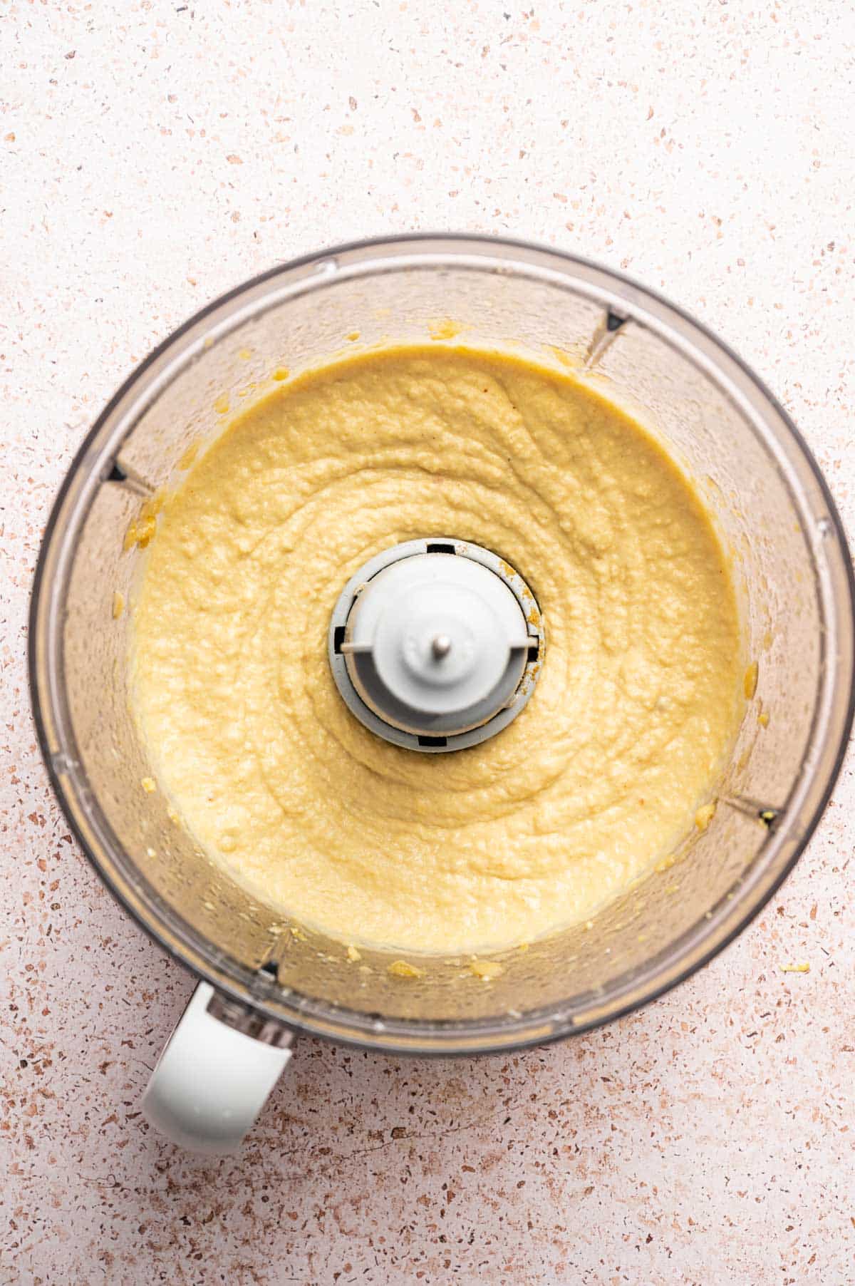 Roasted garlic hummus blended smooth in a food processor.