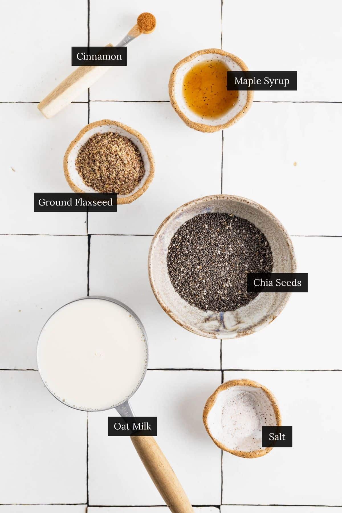 Ingredients for flaxseed and chia pudding on a white tile counter with each ingredient labeled.