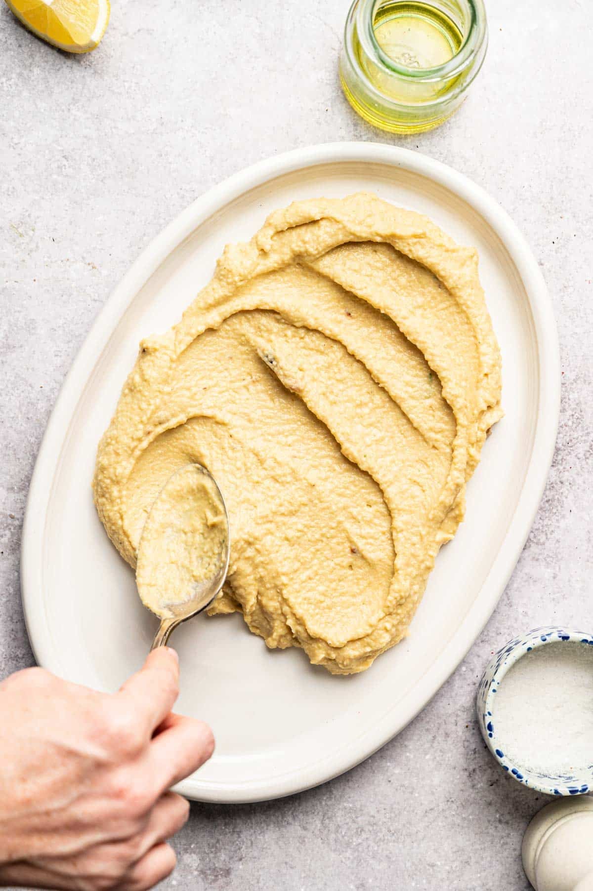 Homemade hummus spread out on a serving platter.